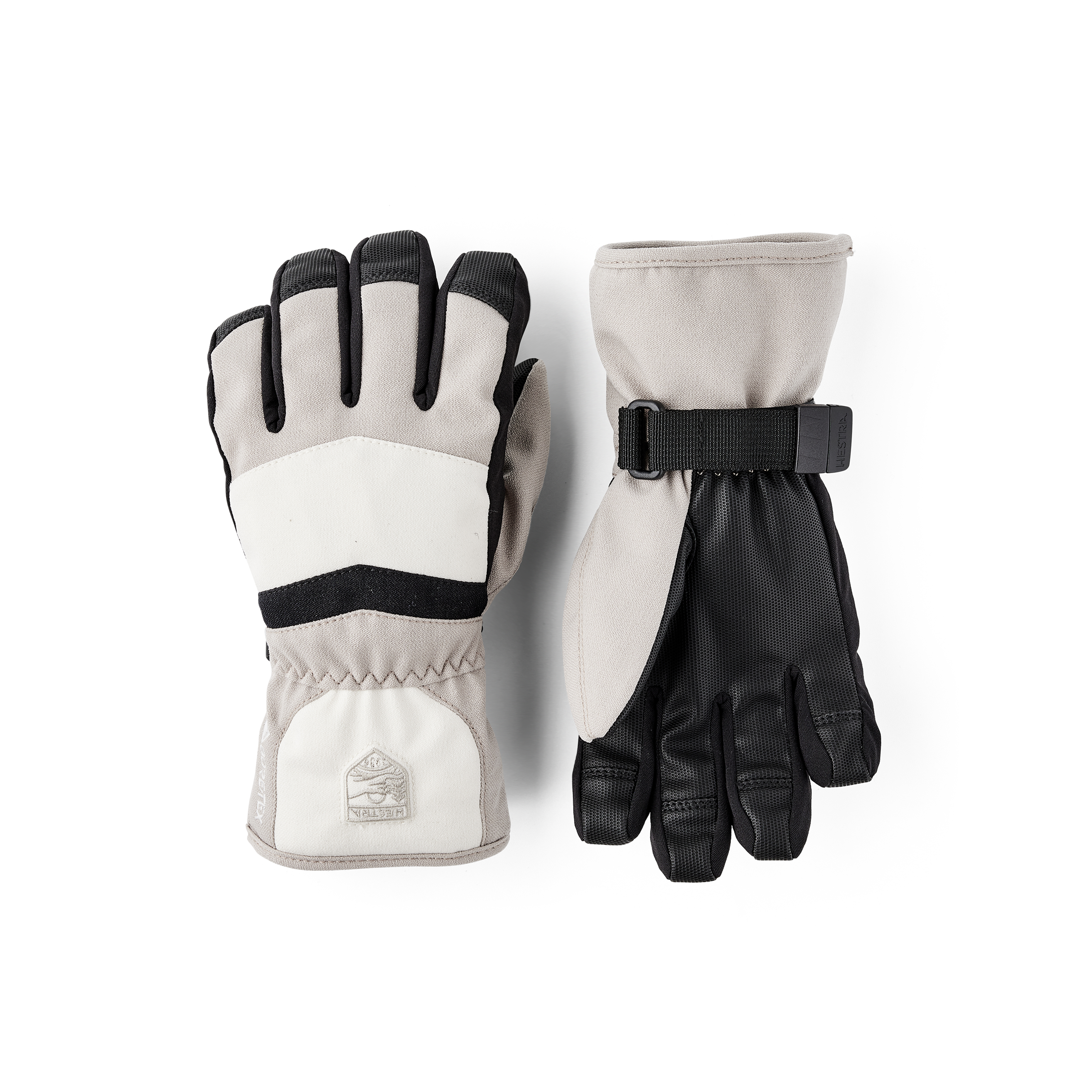 Beige-weißer Kinderhandschuh aus Stoff mit schwarzem Synthetikmaterial an der Innenhand und verstellbarem Handgelenkverschluss
