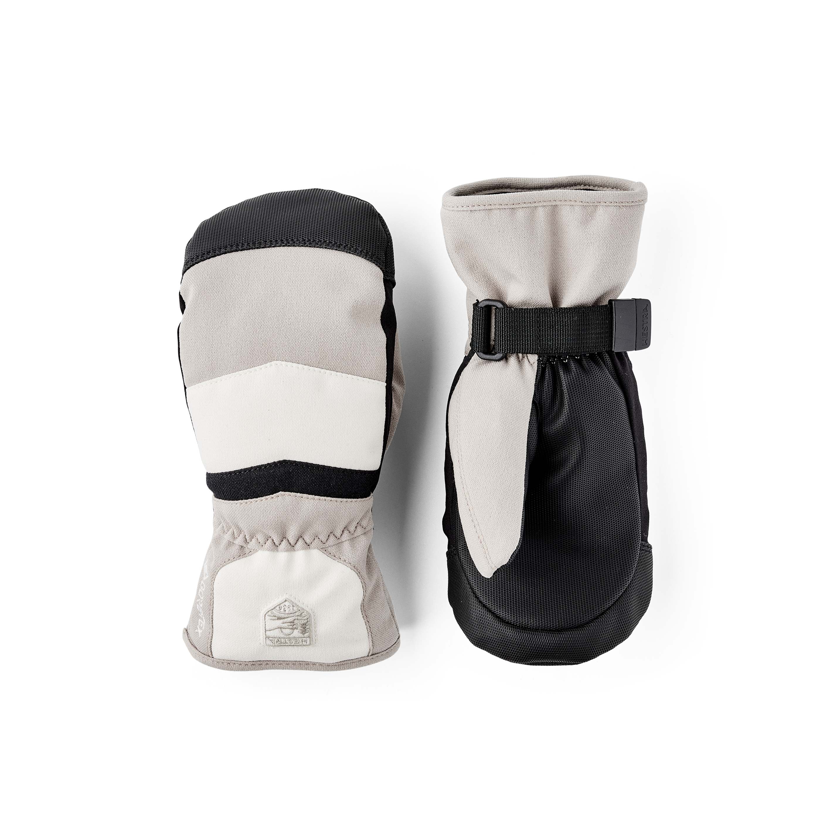 Beige-weißer Fausthandschuh aus Stoff mit schwarzem Synthetikmaterial an der Innenhand und verstellbarem Handgelenkverschluss