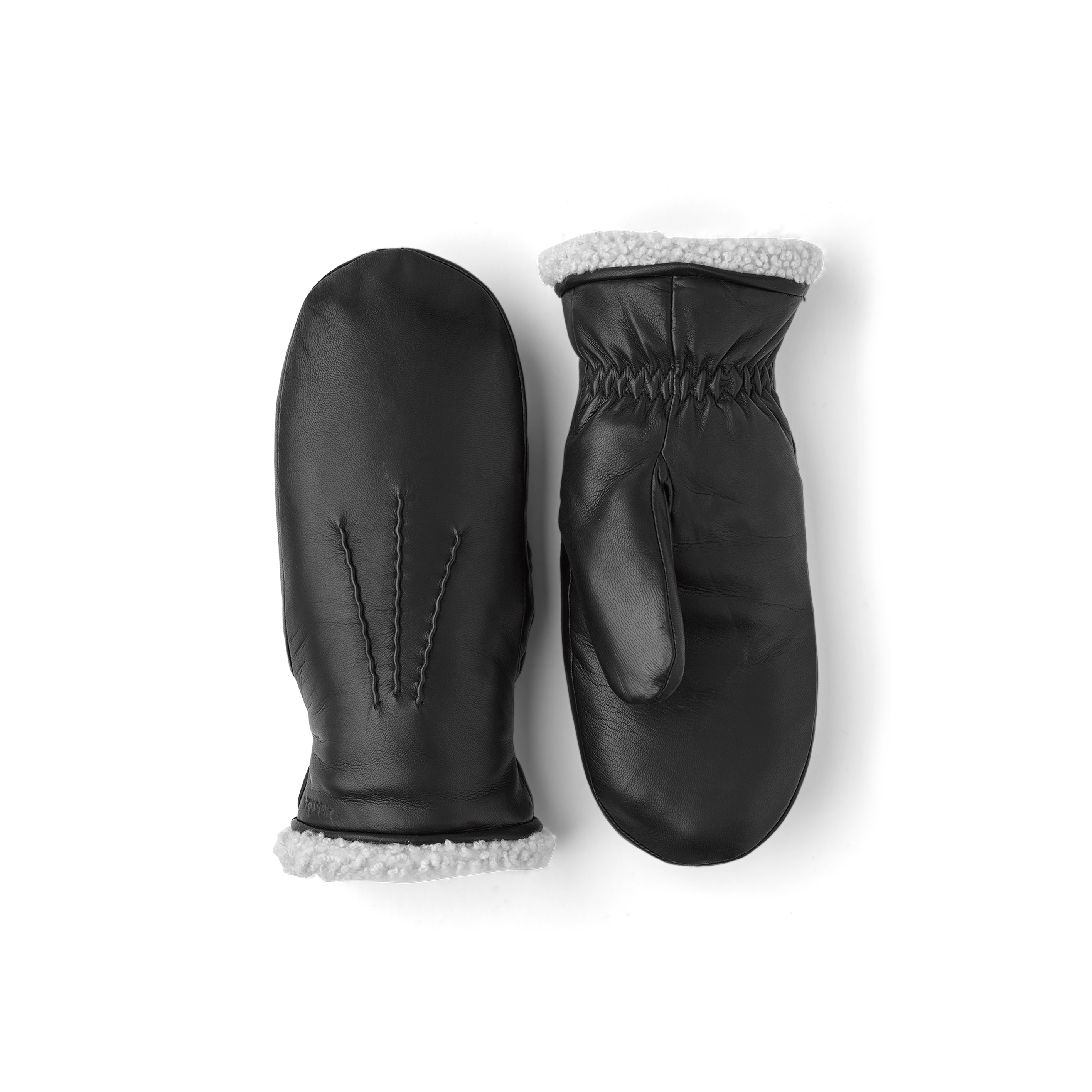 Schwarzer maschinengenähter Fausthandschuh aus Haarschafleder mit weißer Fellstulpe